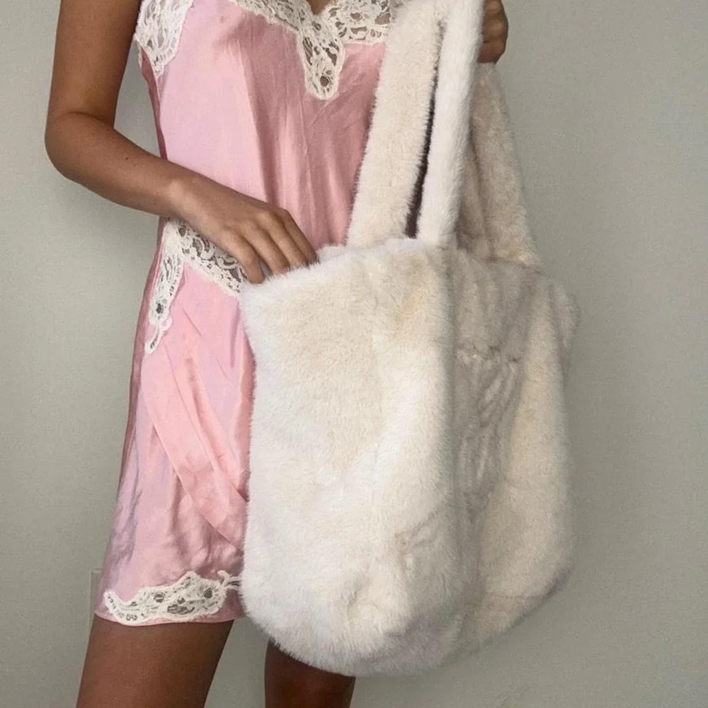 oversized white faux fur tote bag with embroidered logo